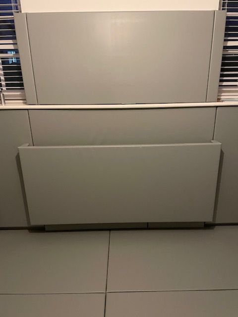 a grey padded room with a padded radiator