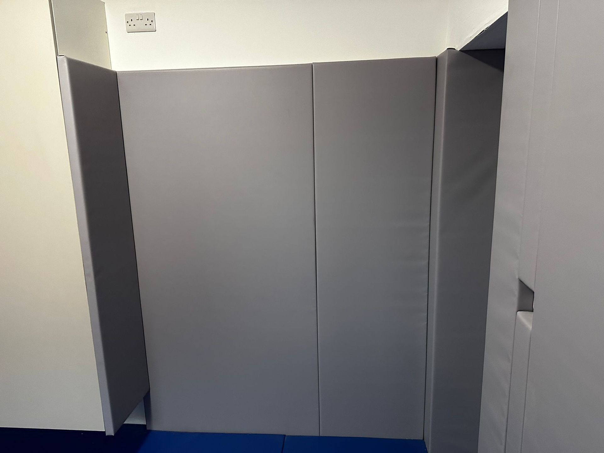 a grey padded wall