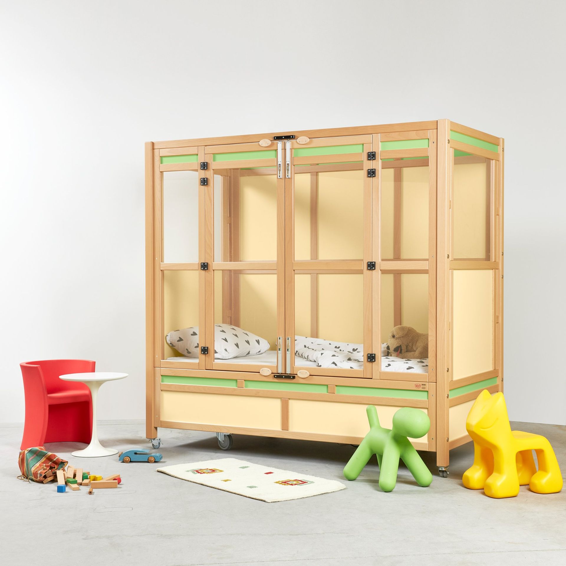 Arran cot in a room with toys beside it