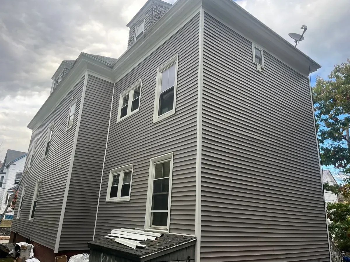 A large house with a lot of windows and a satellite dish on the roof.