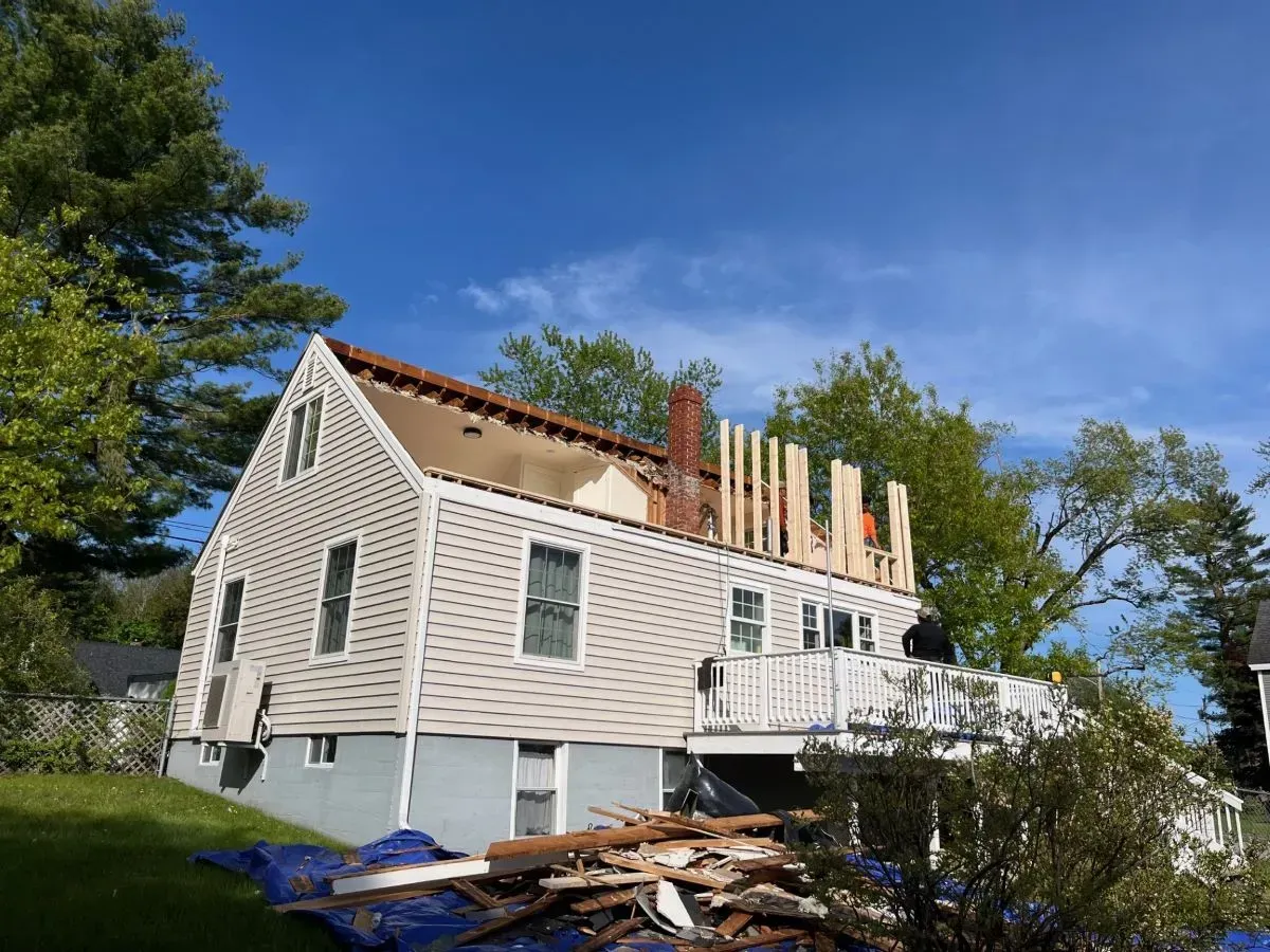 A house with a roof that is being remodeled.