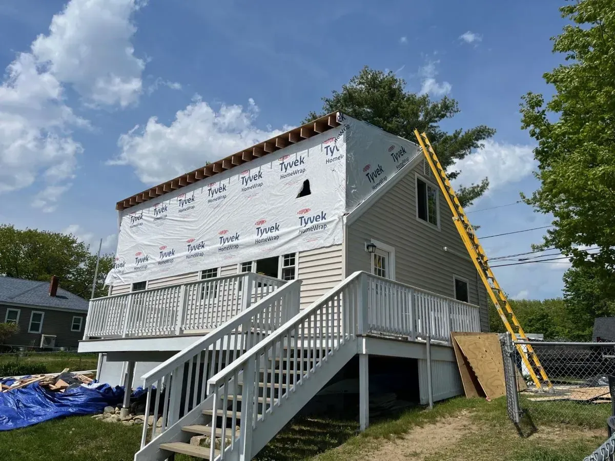 A house is being remodeled with a deck and stairs.