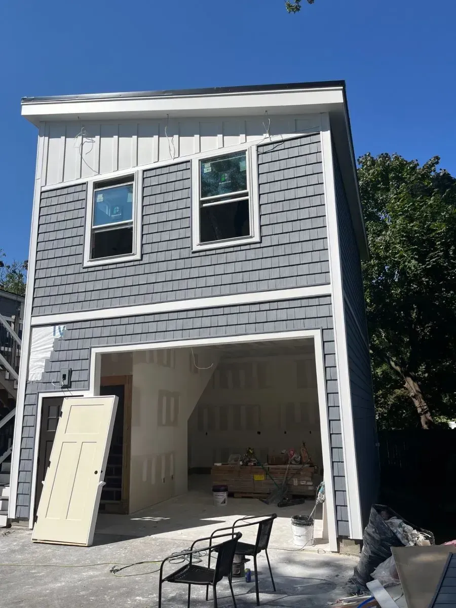 A house with a garage underneath it is being built.
