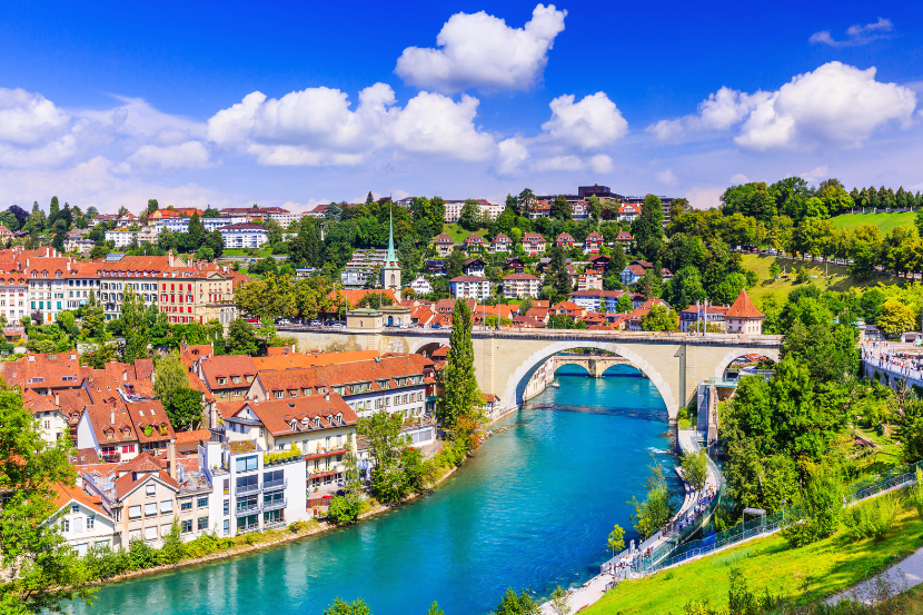 Scenic European riverside city with bridge and old town buildings