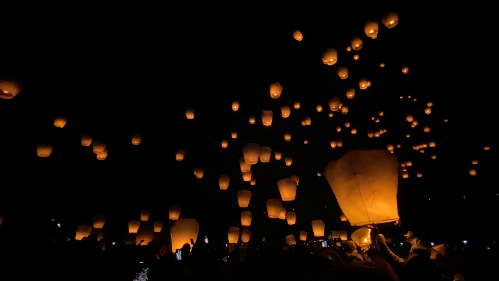 Sky lanterns floating at night during Pingxi Lantern Festival in Taiwan