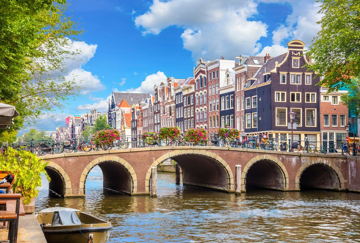 Amsterdam canal with historic buildings and bridge in the Netherlands