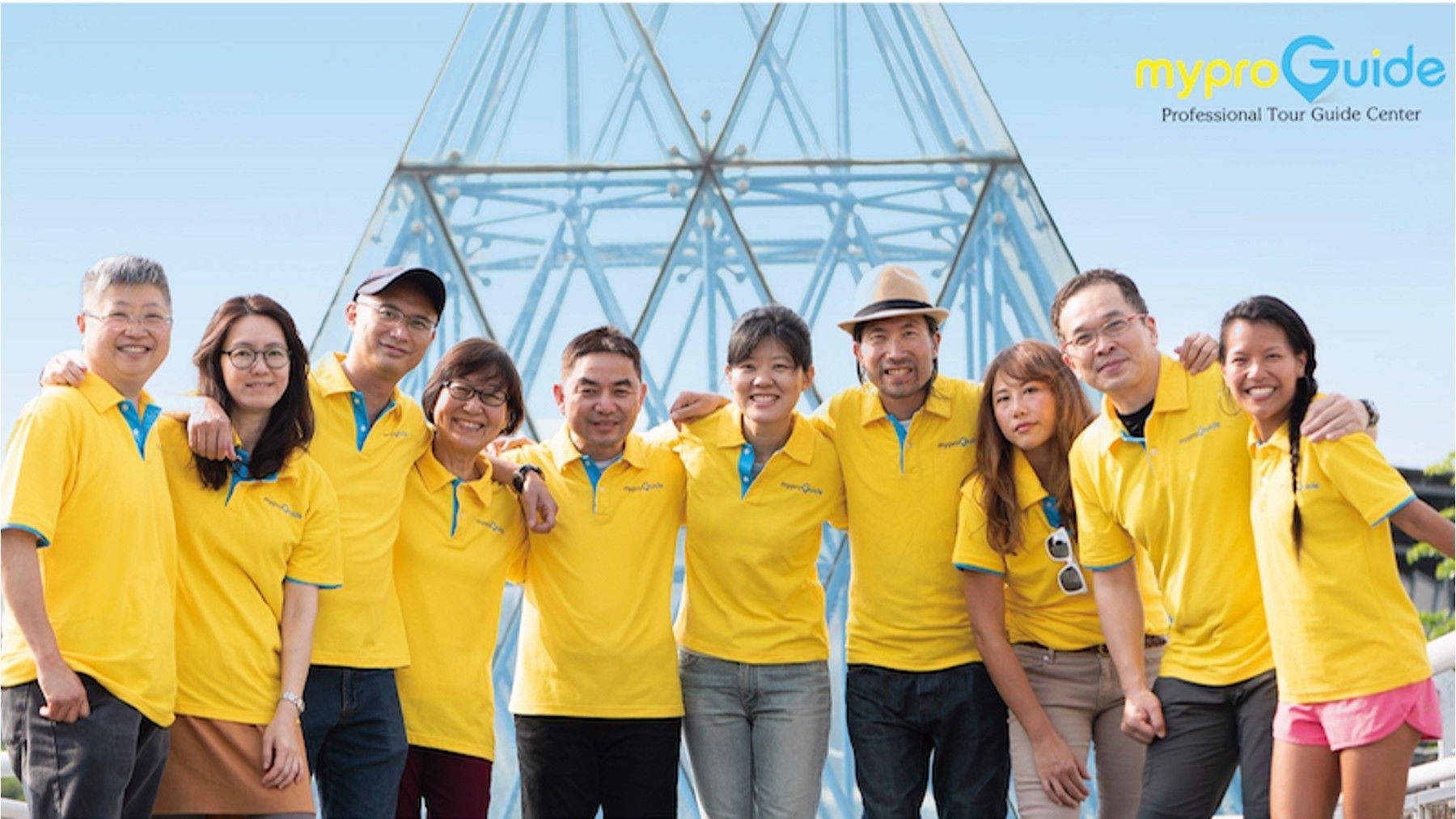 MyProGuide local guides wearing yellow uniforms in a team photo