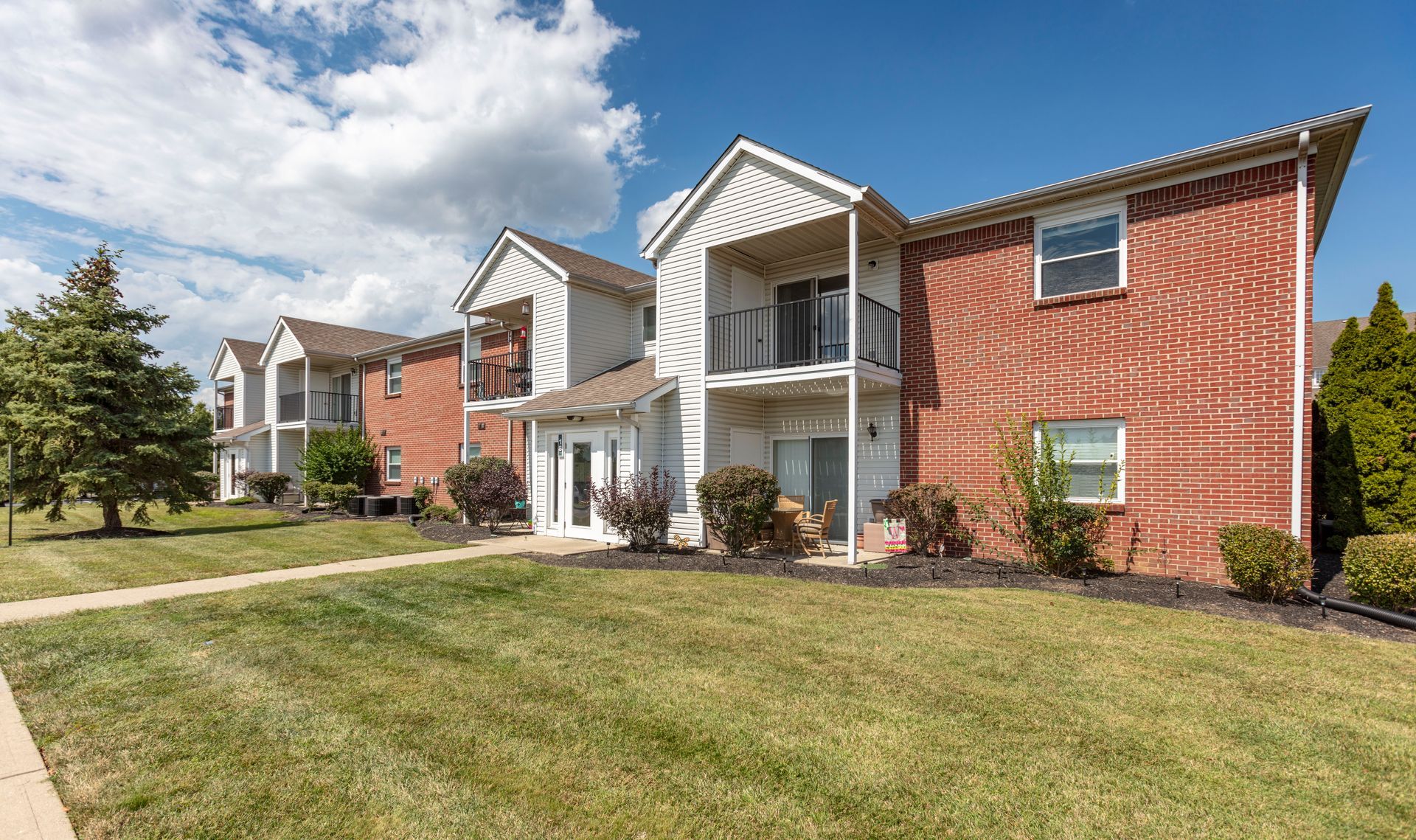 Bridgewater Crossing apartments exterior with green lawn and sidewalks