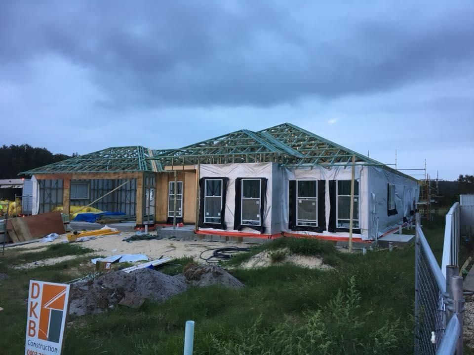 A House Is Being Built In The Middle Of A Field — Mad About Metal Roofing & Guttering PTY LTD in Newcastle, NSW