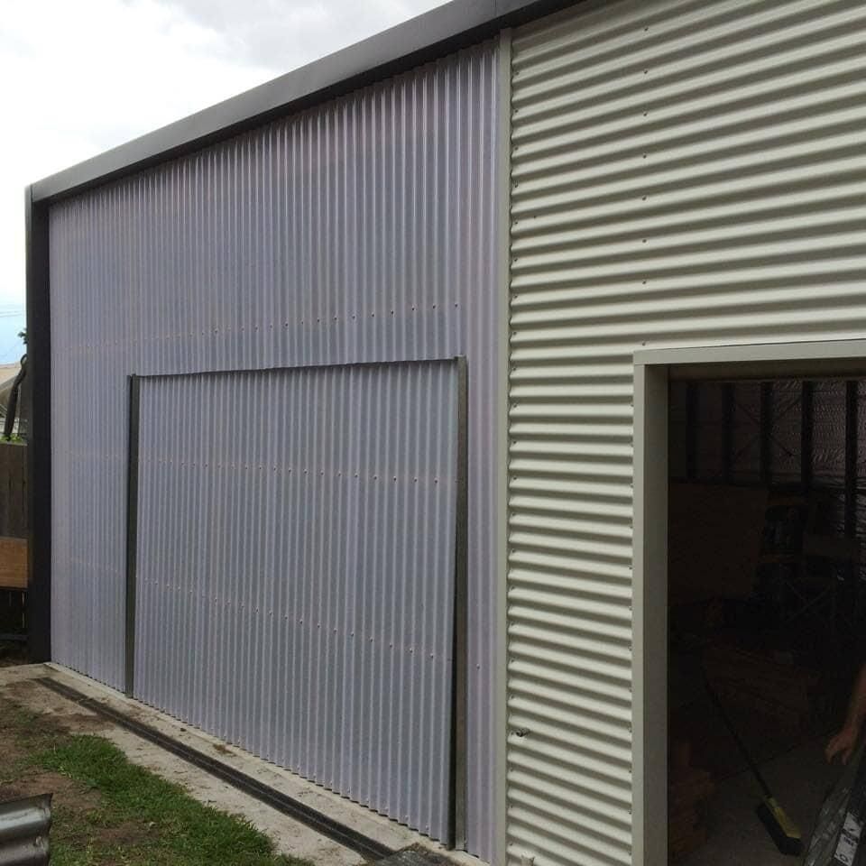 A Building with a Sliding door on the side of it — Mad About Metal Roofing & Guttering PTY LTD in Newcastle, NSW