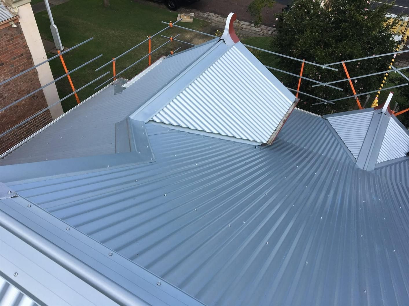 An Aerial View Of A Metal Roof With Scaffolding Around It — Mad About Metal Roofing & Guttering PTY LTD in Newcastle, NSW