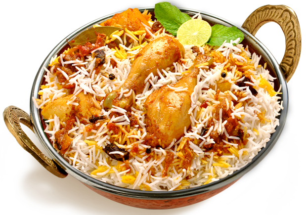 Chicken biryani in a copper pot, garnished with lemon and mint.