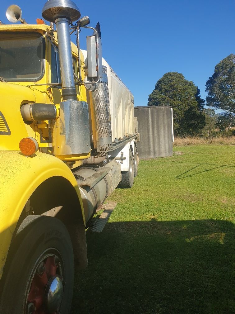 Yellow Train Cab Beside Metal Railings — Taree & Mid Coast Water Cartage in Forster, NSW