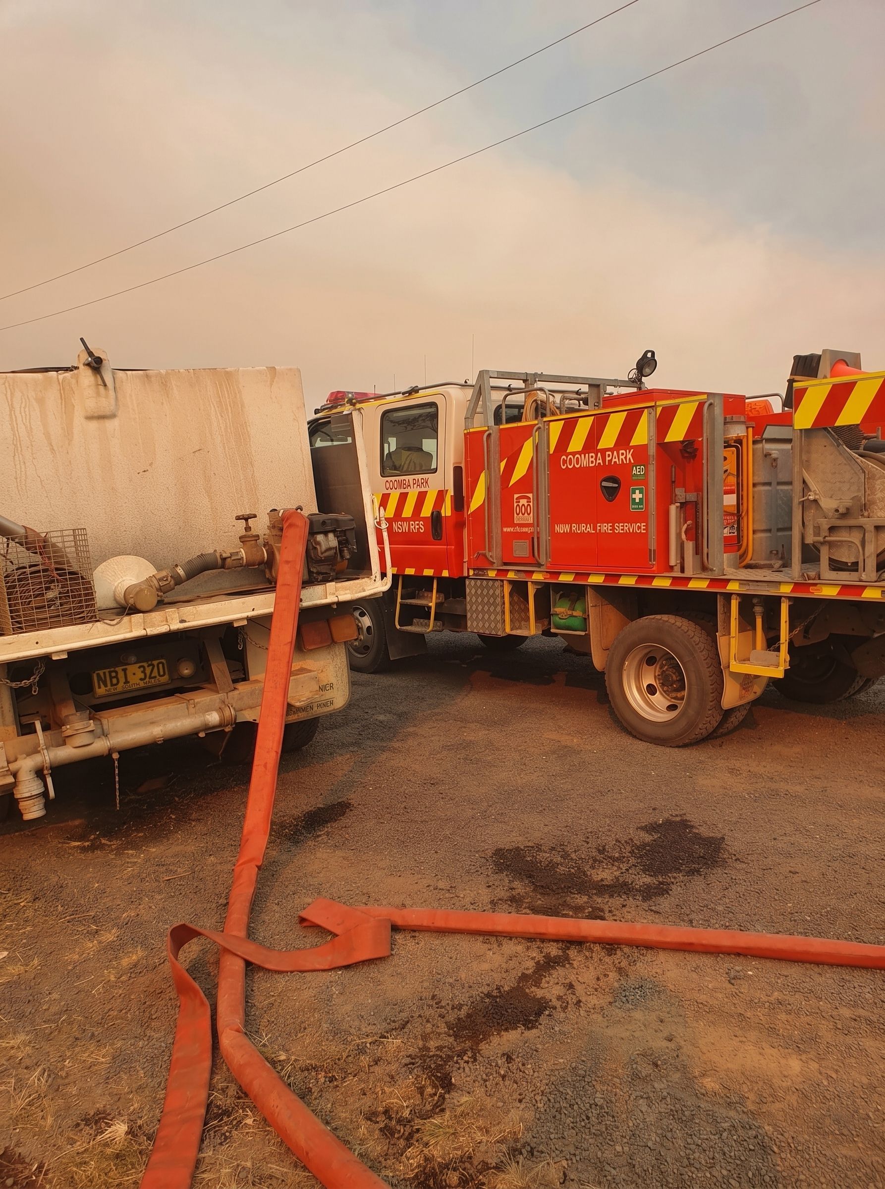 Fire Truck Beside a Tanker Truck — Taree & Mid Coast Water Cartage in Hallidays Point, NSW