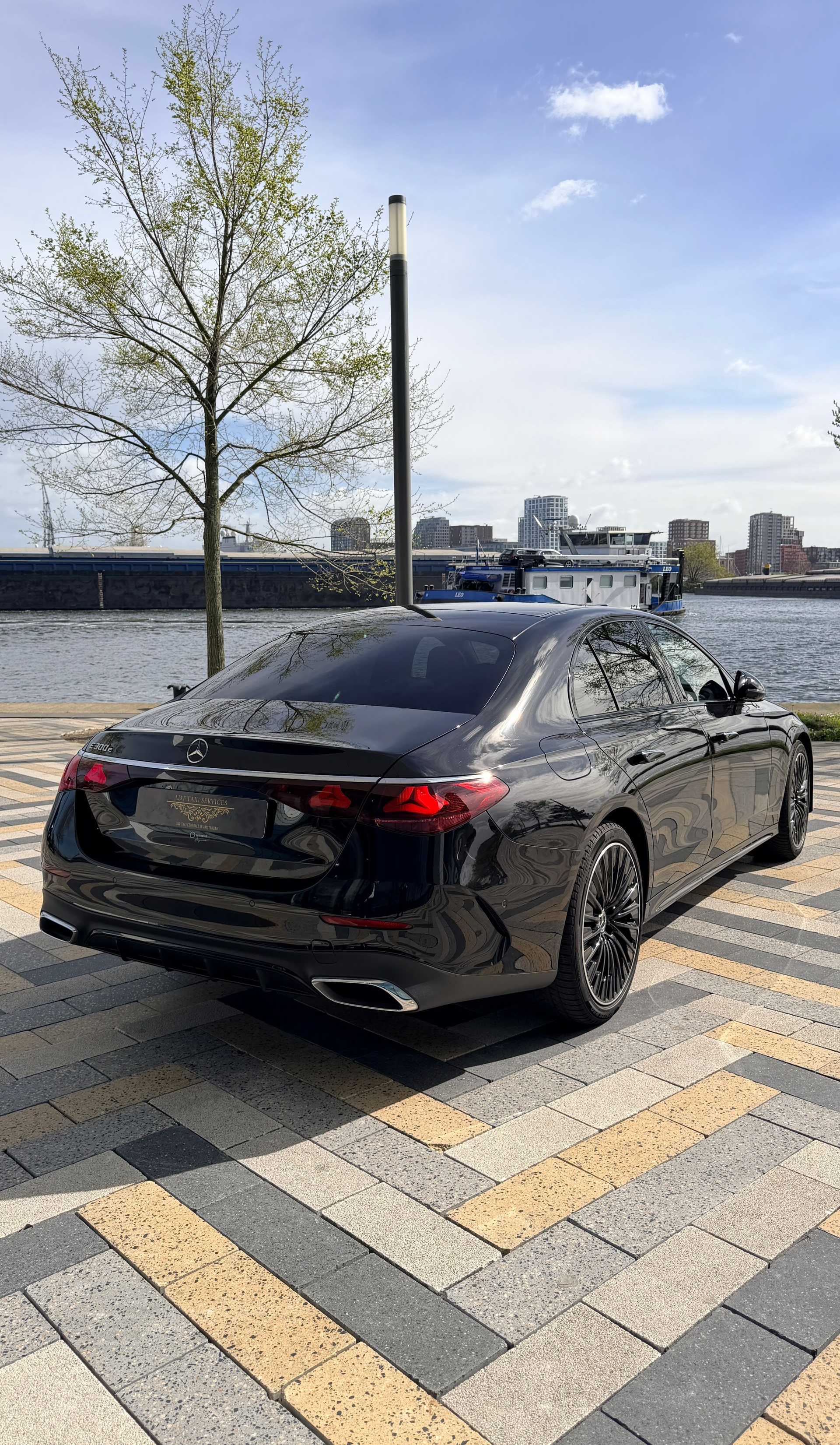 A black mercedes benz s class is parked in front of a building. rent a s class with driver in amsterdam