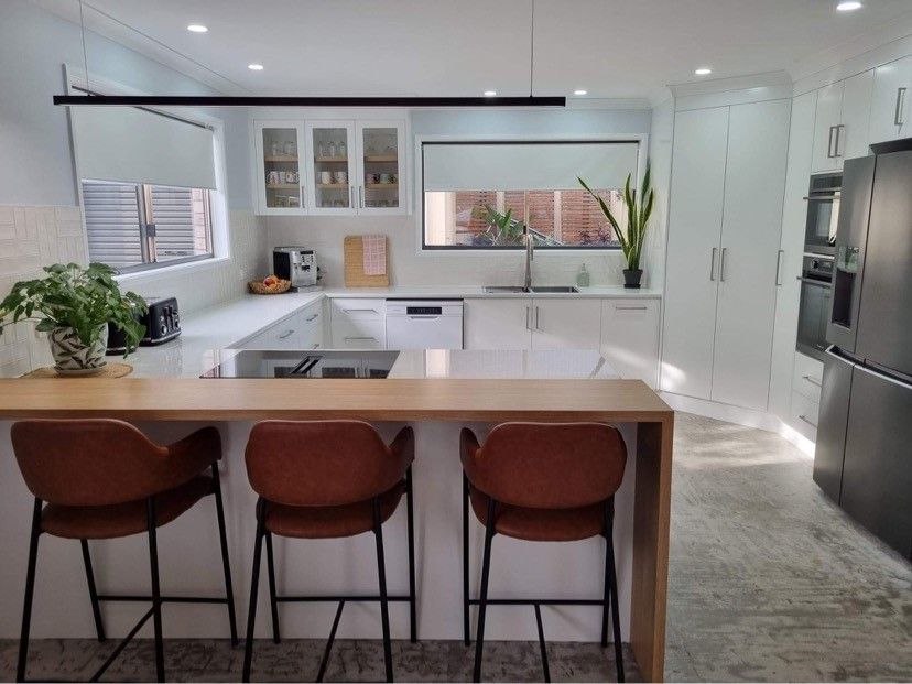 Elegant White Kitchen with Island, Marble Countertops, Floors, and Chandelier — Valley Cabinetmakers Pty Ltd In Biloela, QLD 