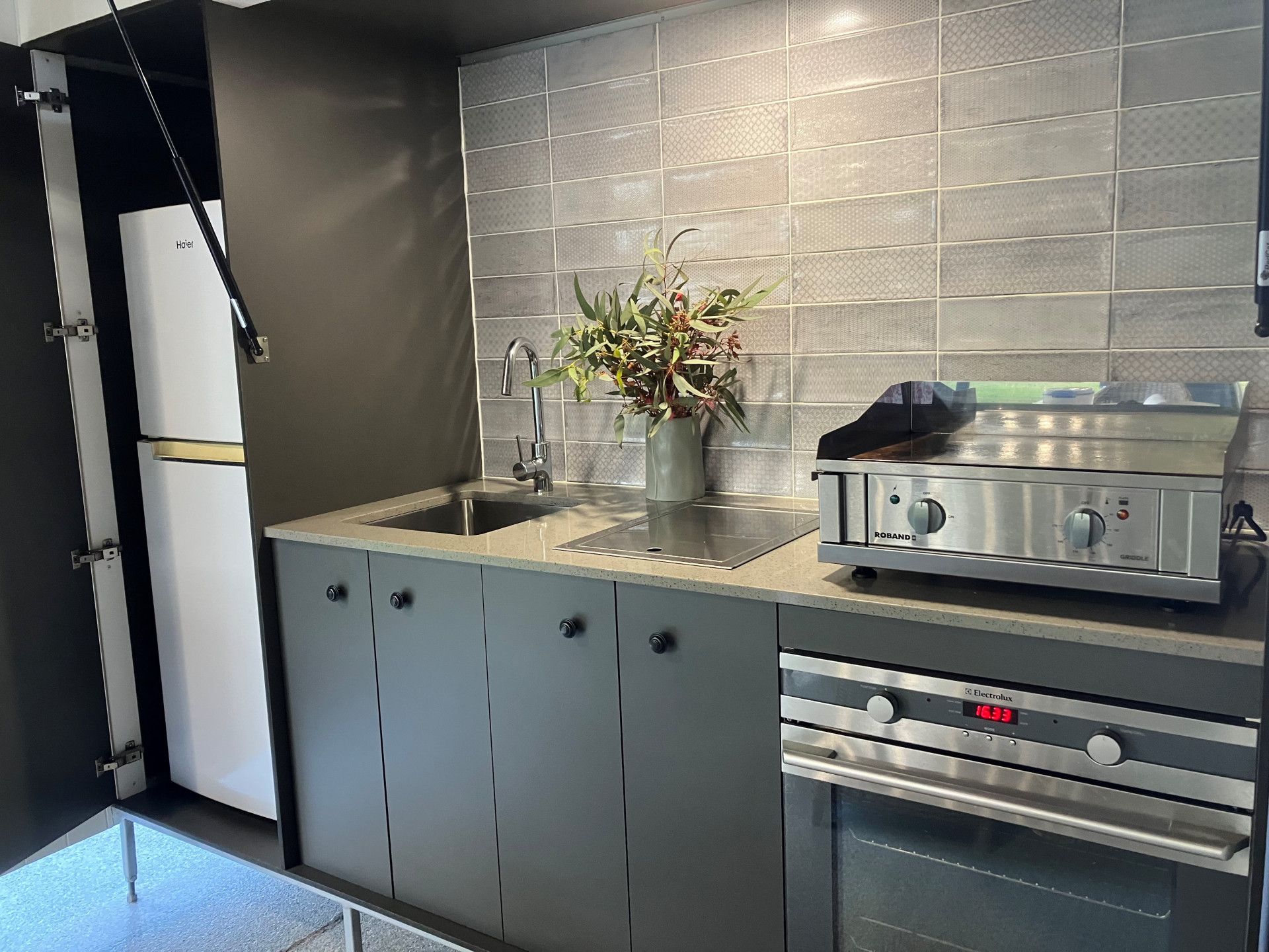 White Kitchen With Island, Cabinets, and a Plant in a White Vase — Valley Cabinetmakers Pty Ltd In Biloela, QLD