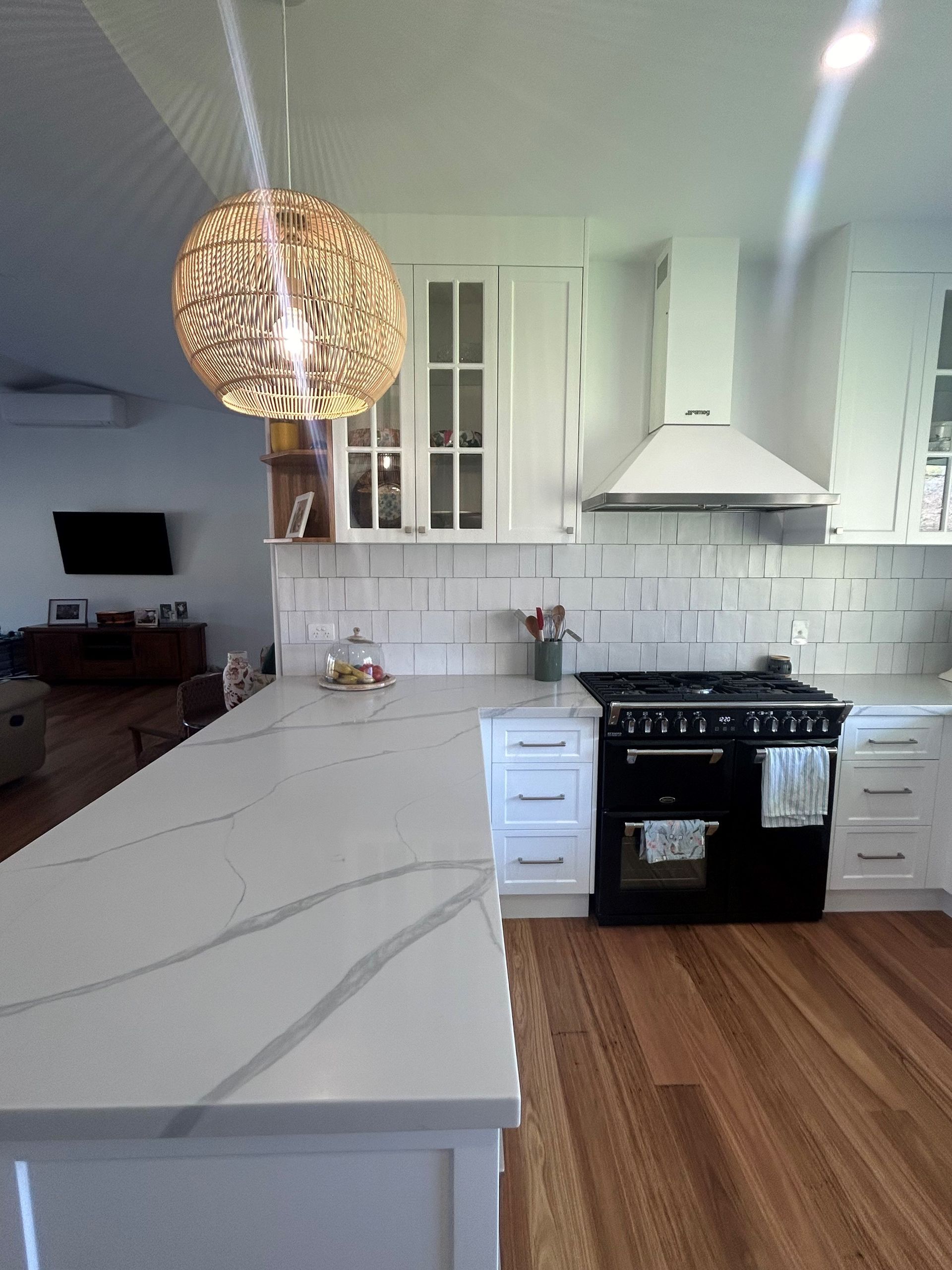 Bright White Kitchen With Marble Island, Black Stove — Valley Cabinetmakers Pty Ltd In Biloela, QLD