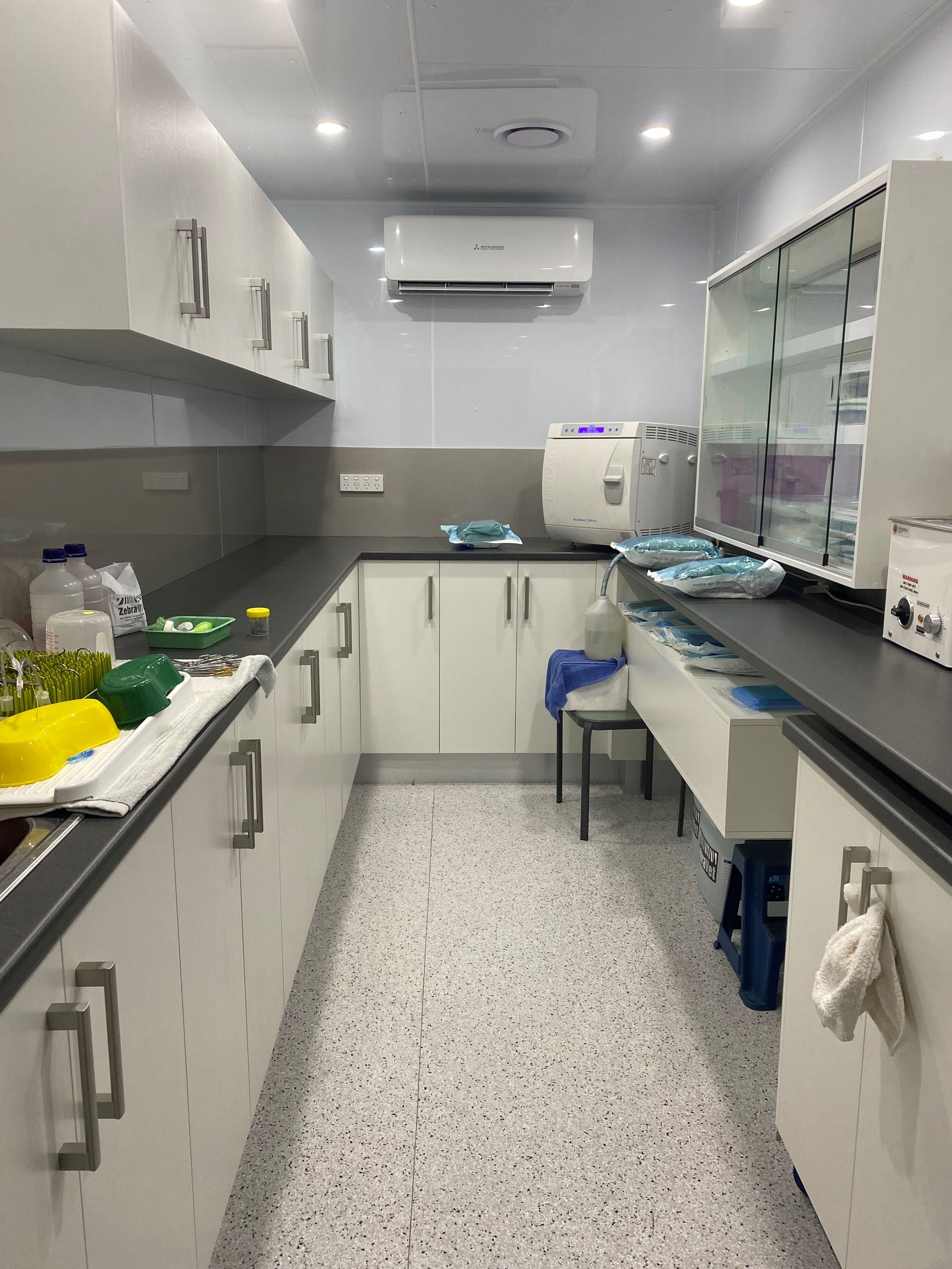 Narrow White Kitchen With Black Countertops, Cabinets, and a Window Shelf — Valley Cabinetmakers Pty Ltd In Biloela, QLD