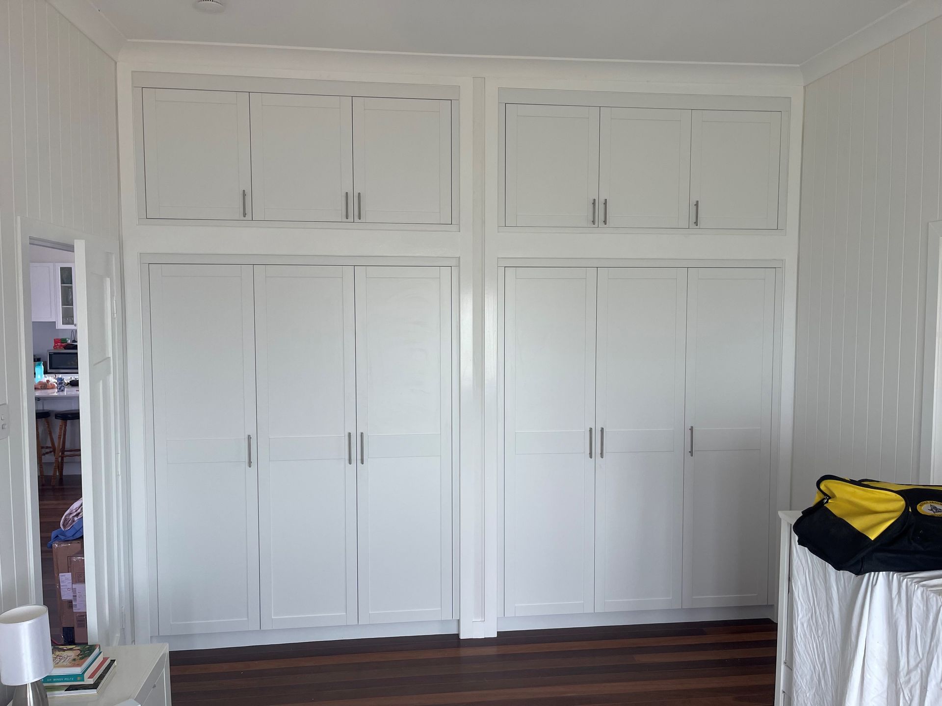 White Built-in Closet Doors With Upper Cabinets in a Bright Bedroom — Valley Cabinetmakers Pty Ltd In Biloela, QLD 