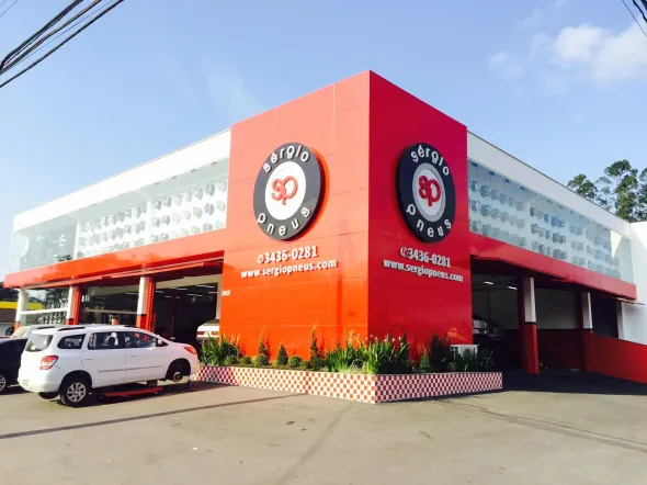 um grupo de carros está sentado um ao lado do outro em um fundo branco com a Logo Marca da Grupo Open Seminovos