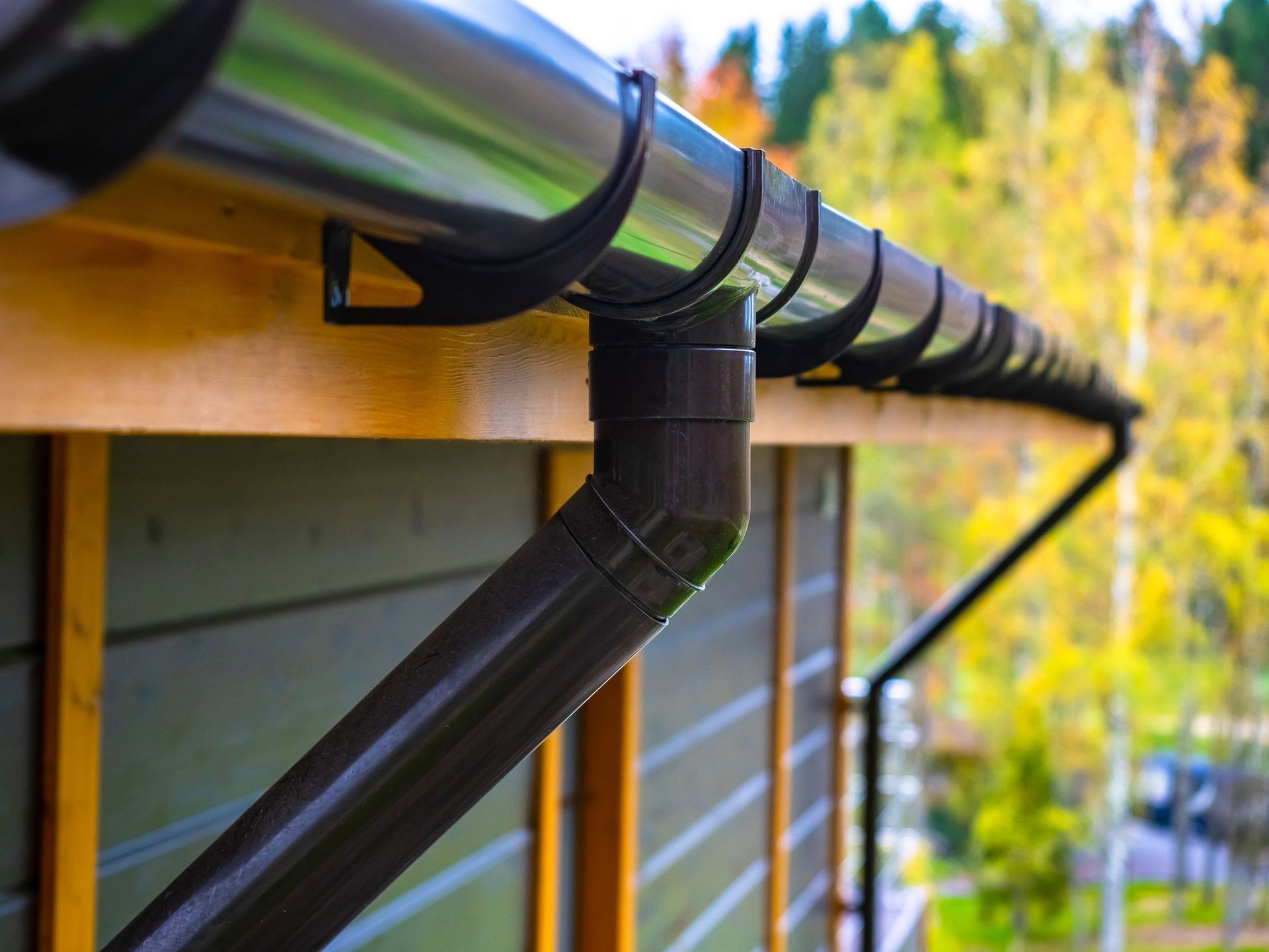 A close up of a gutter on the side of a building.