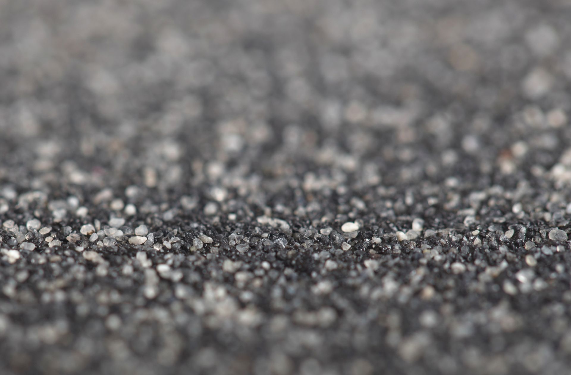 A close up of a black surface with white dots on it.