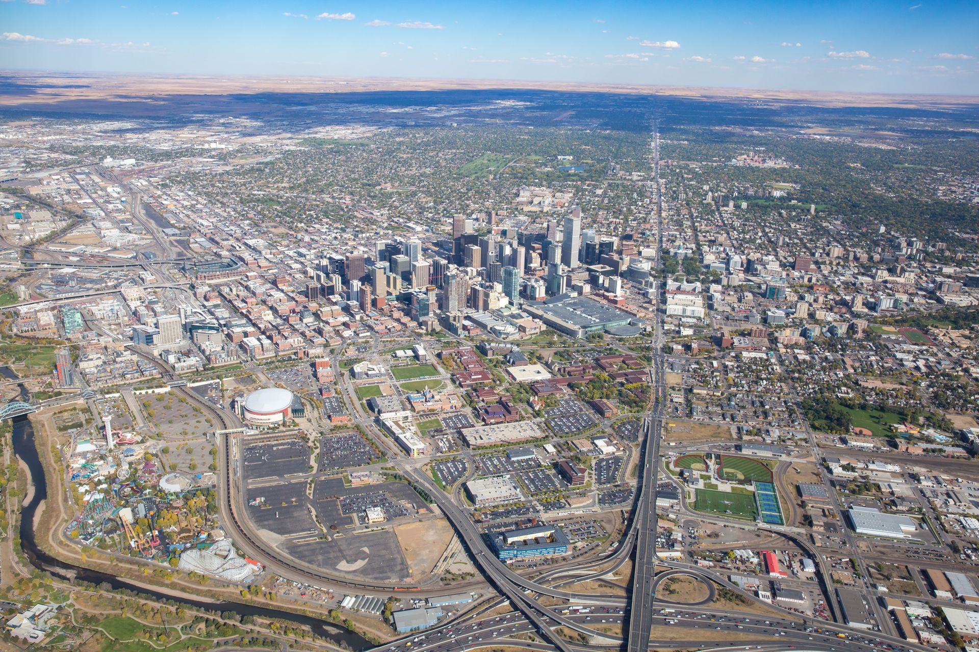 Aerial view of Denver, Colorado with downtown buildings, highways, and the South Platte River.