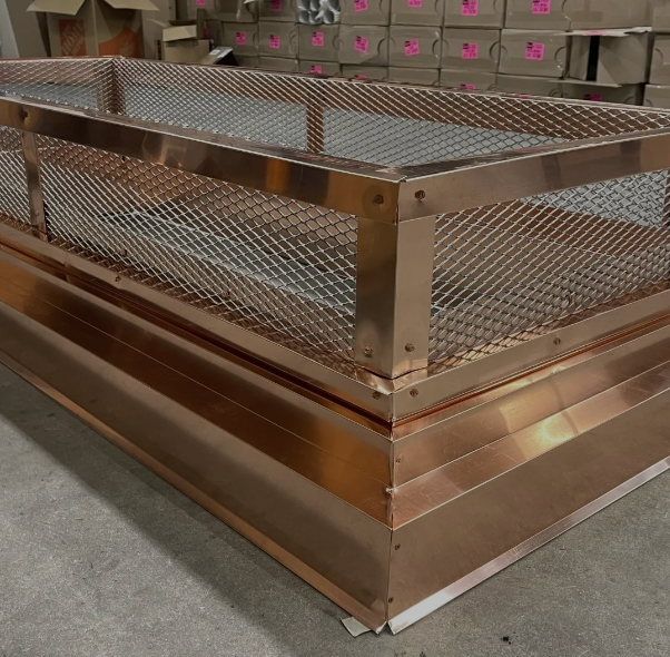 A copper box with a mesh fence around it