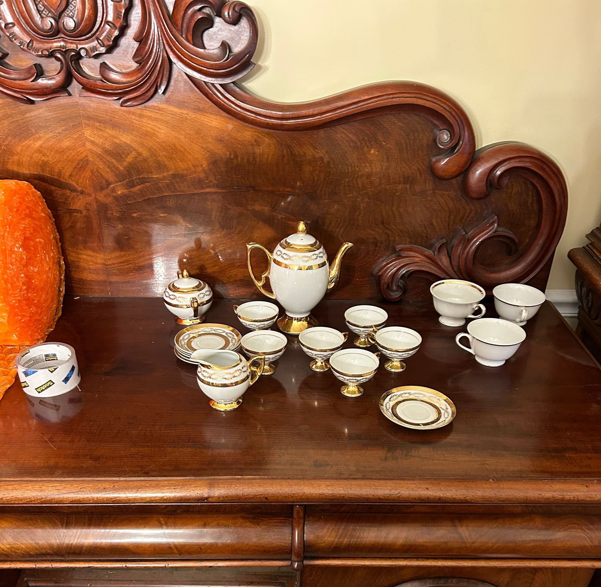 A wooden table with a tea set on it