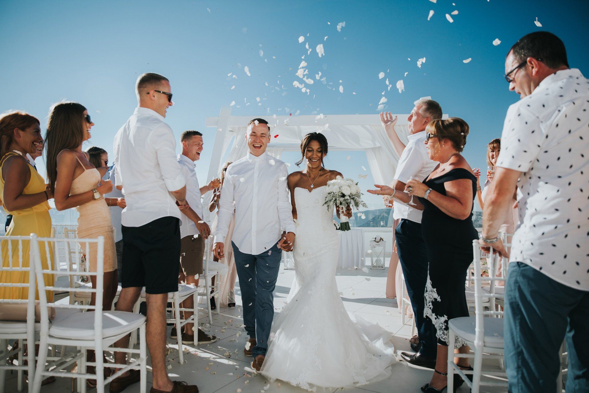 Bride and Groom Photograph against white wall at destination wedding in Santorini
