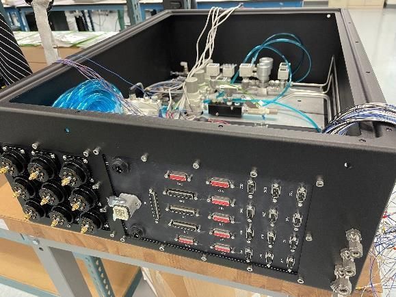 A black box with a bunch of wires coming out of it