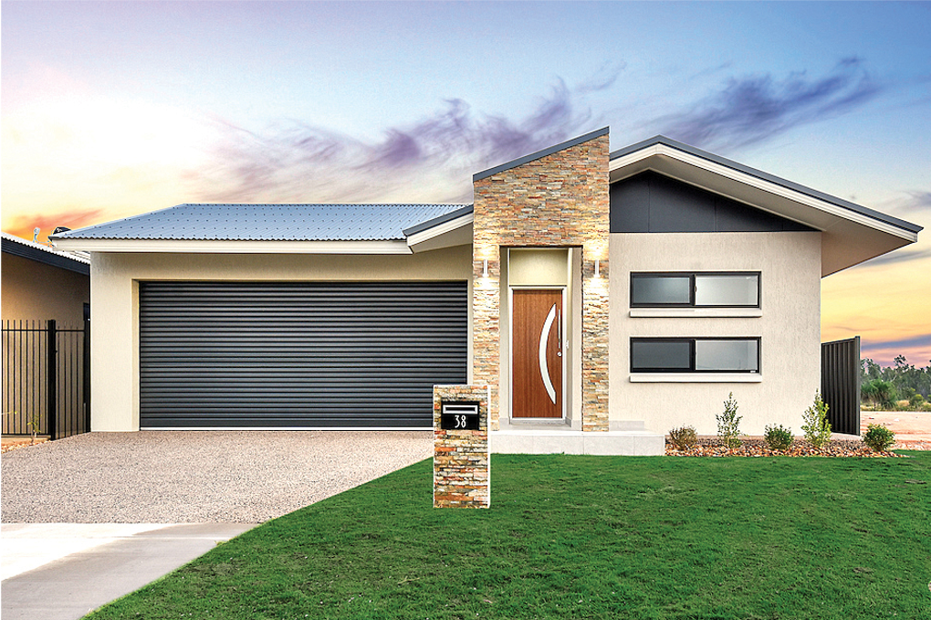 Modern house with grey garage door, stone accent, lawn, and blue sky.