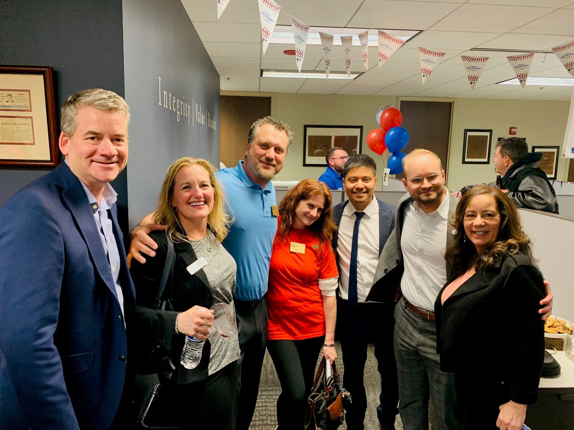 A group of people are posing for a picture in an office.