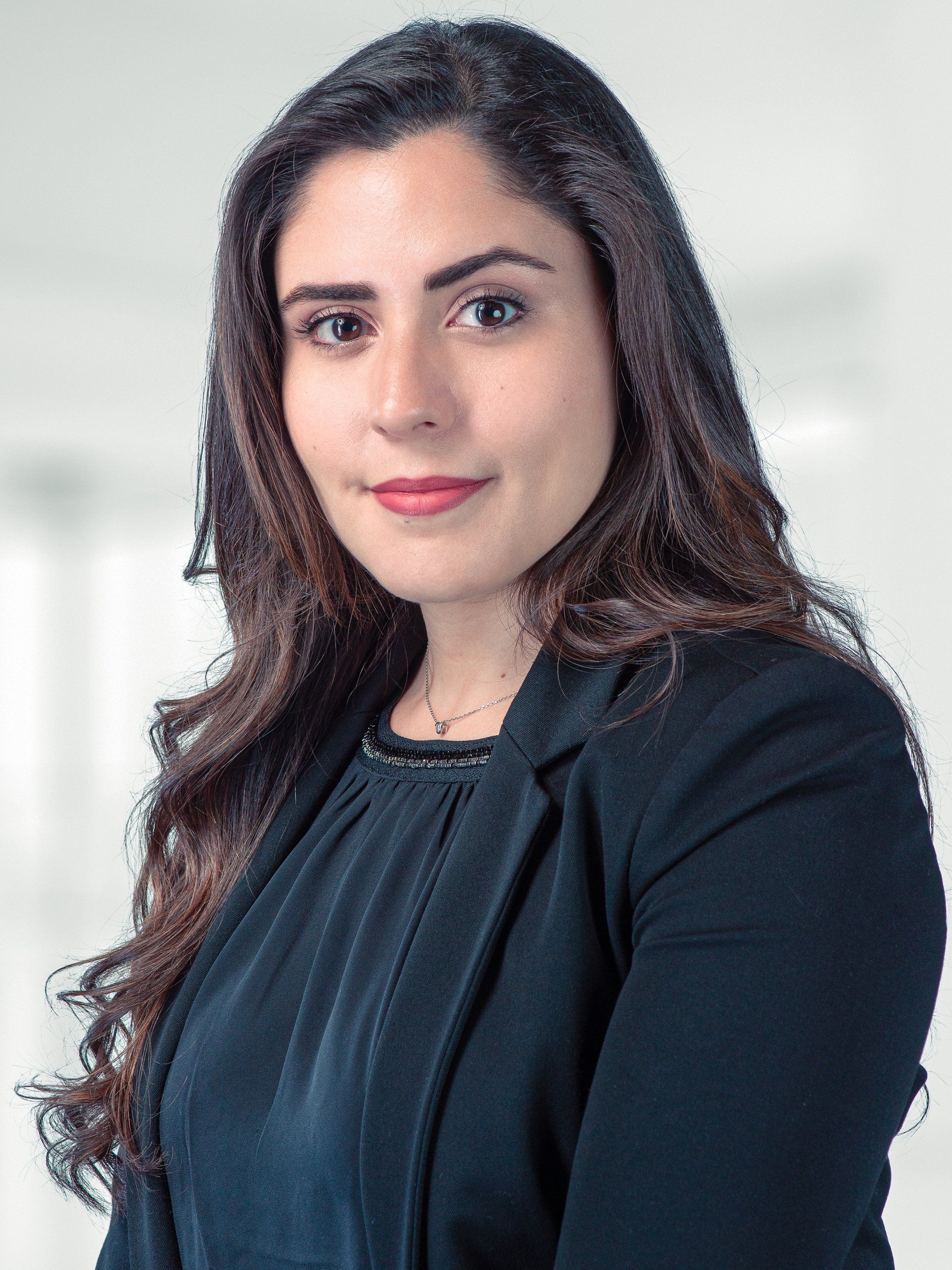 A woman with long hair is wearing a black jacket and a black shirt.