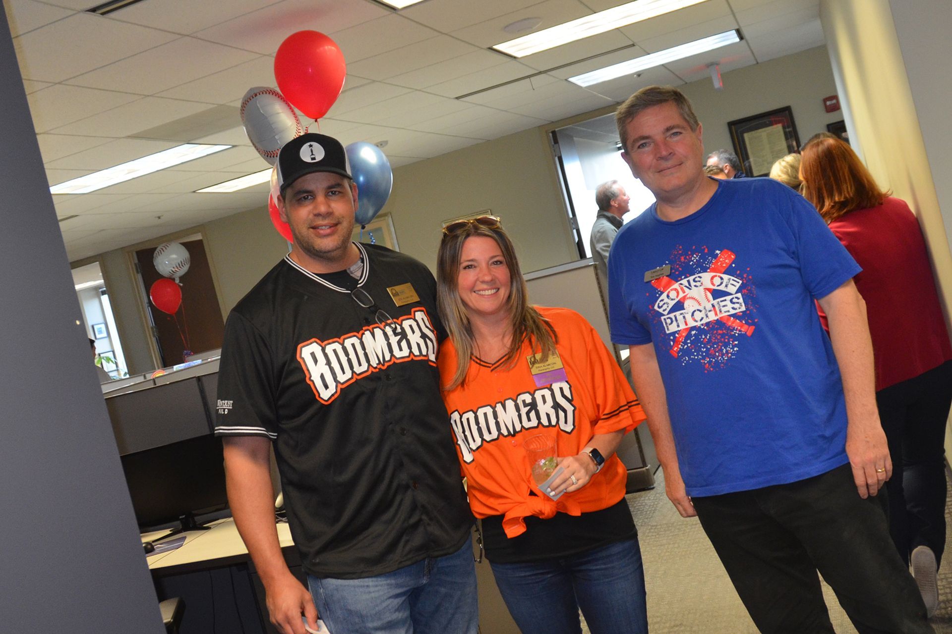 A group of people are posing for a picture in an office.