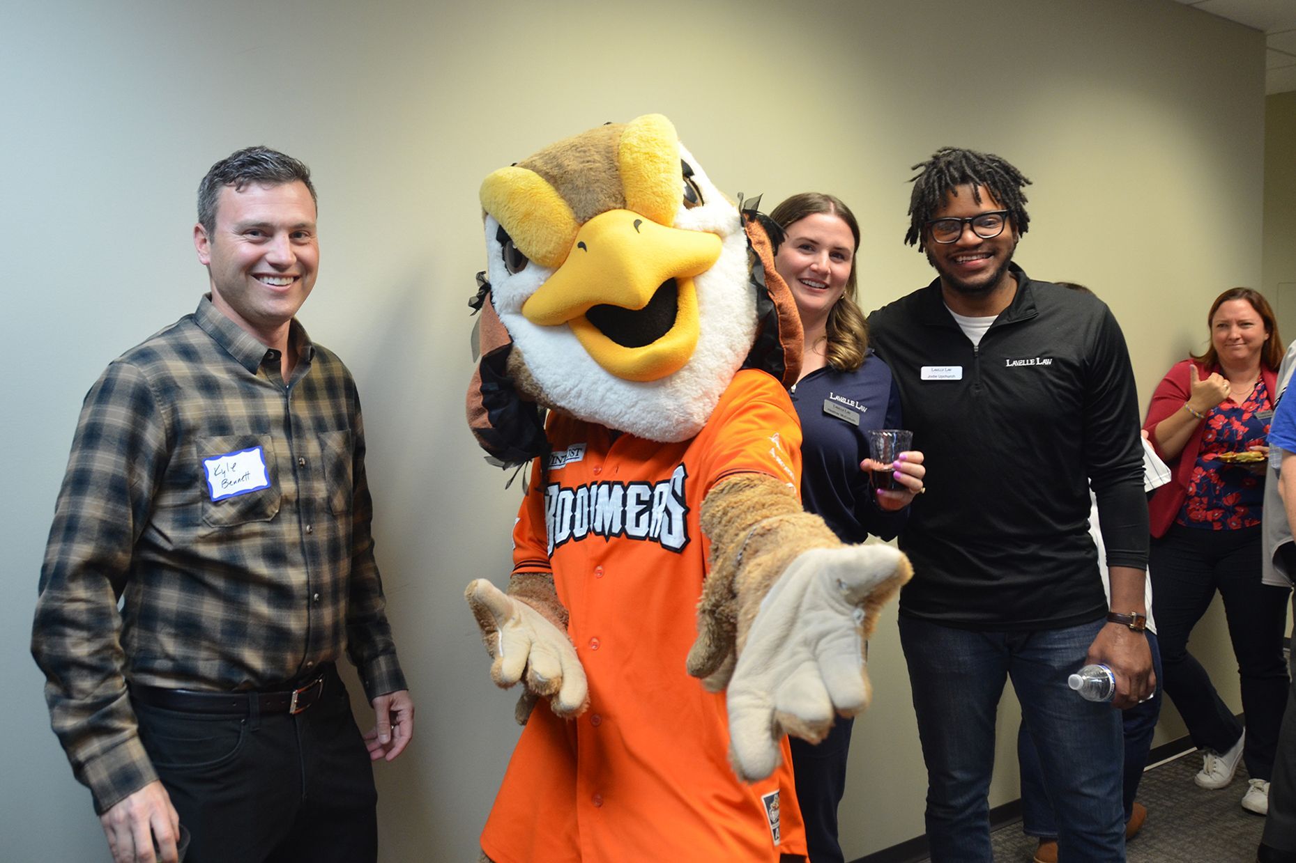 A group of people are posing for a picture with a mascot.