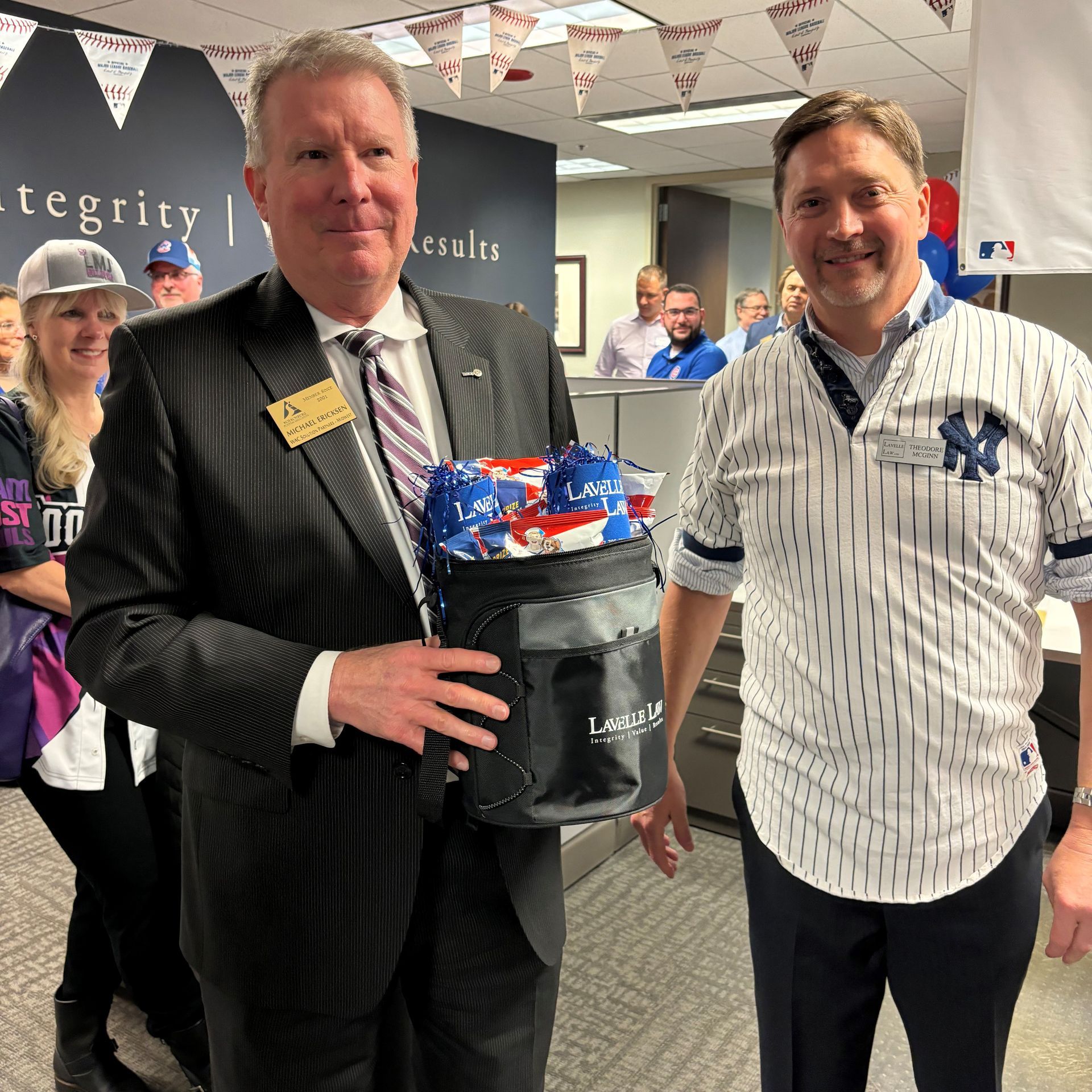 Two men are standing next to each other and one is wearing a new york yankees jersey