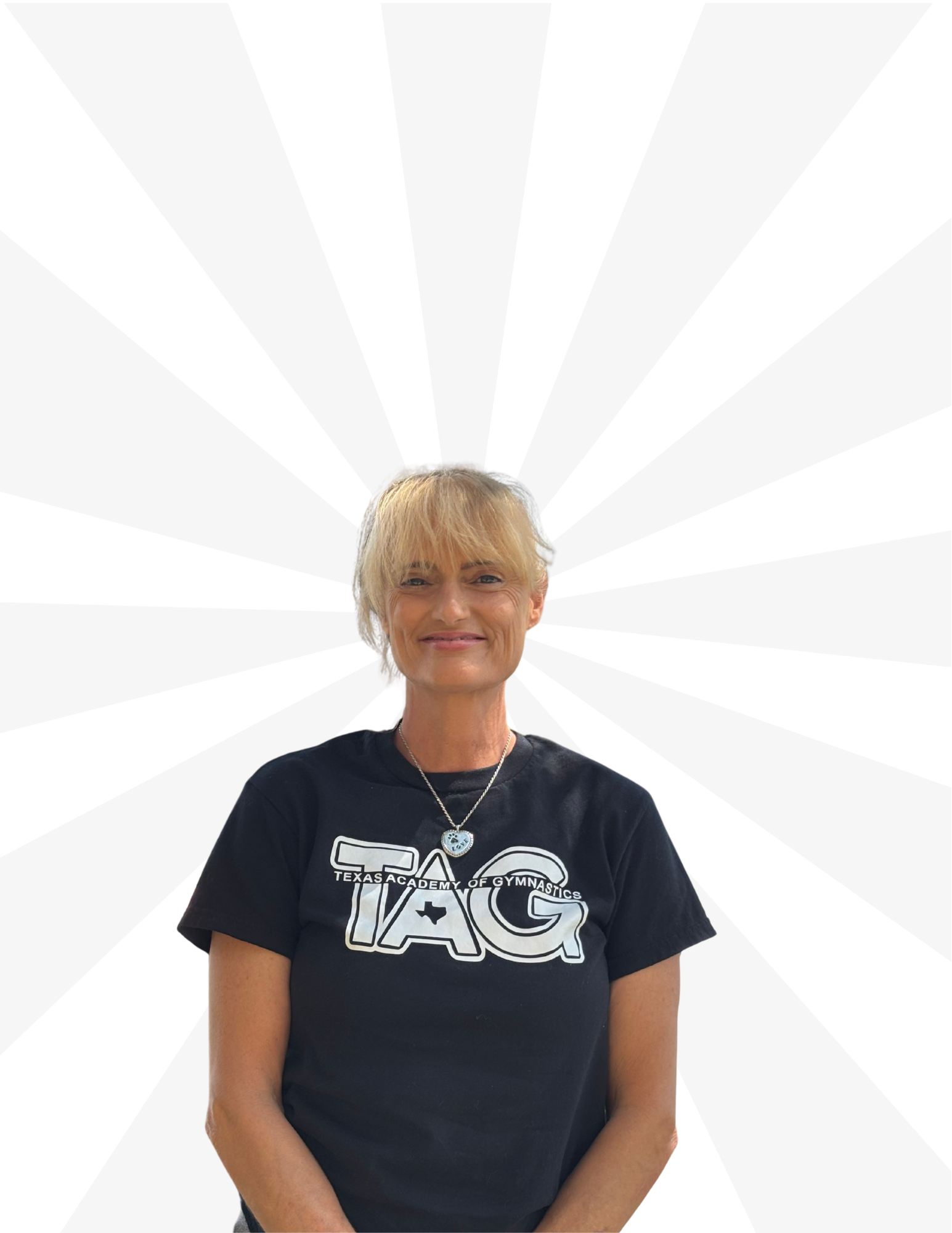 A smiling person wearing a black t-shirt with the word 