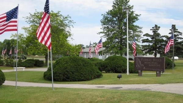 American flags along a landscaped road with trees, shrubs American flags along a landscaped road with trees, shrubs