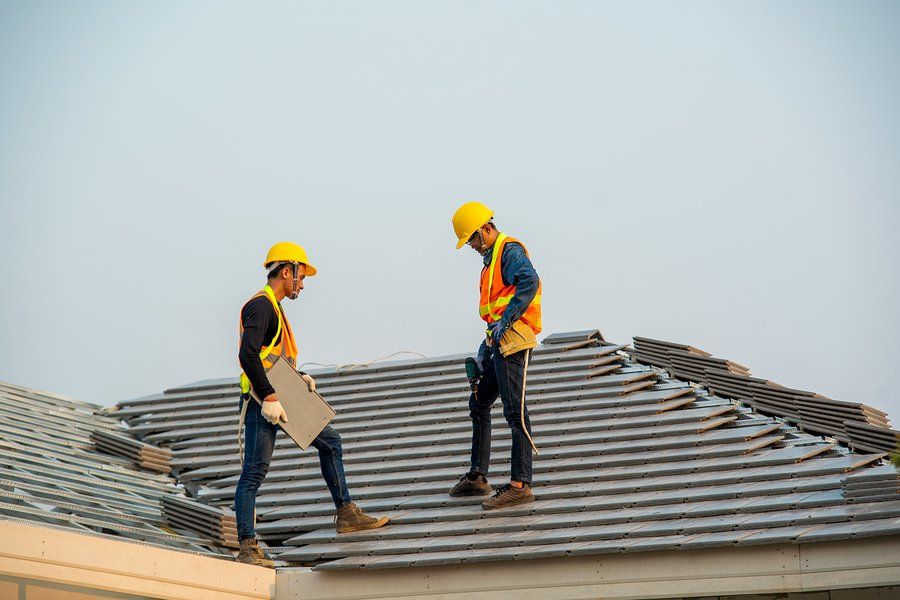 two workers checking the roof tile
