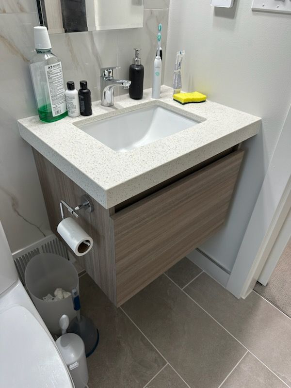 A bathroom with a sink and toilet paper holder