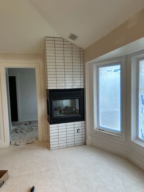 A room with a fireplace in the middle of it