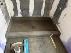 A shower stall is being built in a bathroom.