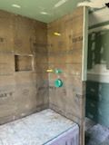 A bathroom with a walk in shower and a bathtub.