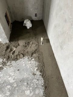 A black and white photo of a bathroom under construction.