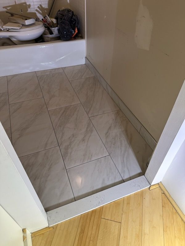 A bathroom with a bathtub and a tiled floor.