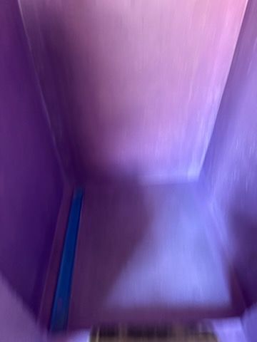 A close up of a purple box with a blue stripe on the side.