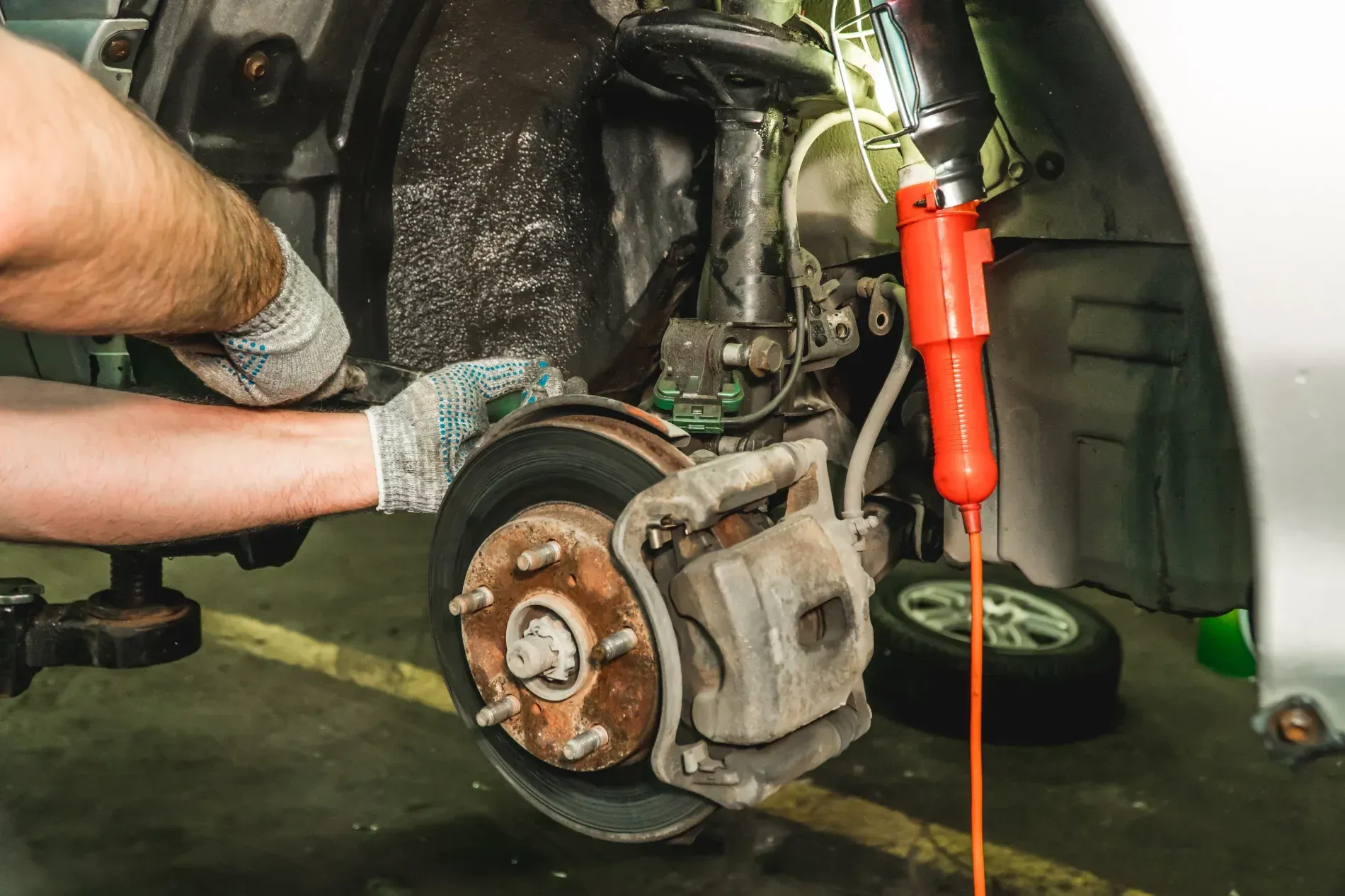 Mechanic Working on Car Brake, Using a Wrench — Elite Fleet Auto - Electrics & Mechanical in Proserpine, QLD