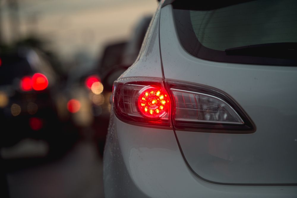 White Car's Brake Light Illuminated Red in Traffic — Elite Fleet Auto - Electrics & Mechanical in Bowen, QLD